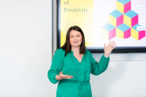 Carly Cannings, Founder of The Happy Business School delivering a keynote.