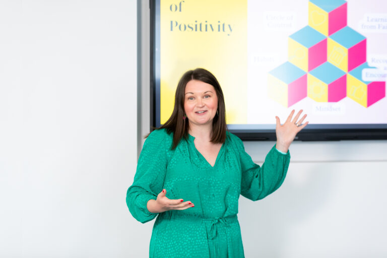 Carly Cannings, Founder of The Happy Business School delivering a keynote.